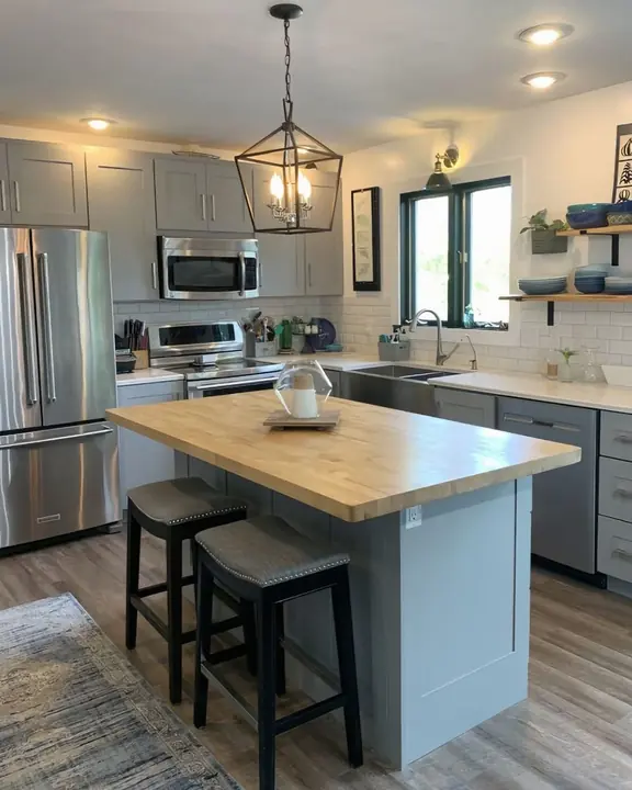 Gray shaker kitchen with butcher-block island and subway tile